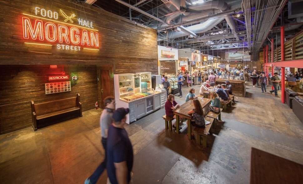 Morgan Street Food Hall restaurant sign with people eating nearby