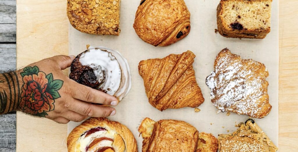Hand takes croissant on tray
